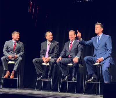 Men on stage at an event.