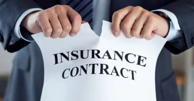 Man ripping up insurance contract.