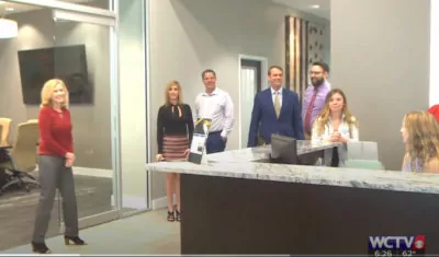 People in office reception area.